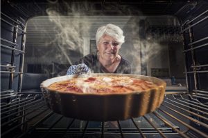 woman opening oven
